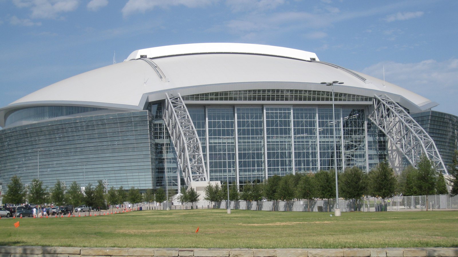 AT&T Stadium in Arlington, Texas, under a bright blue sky