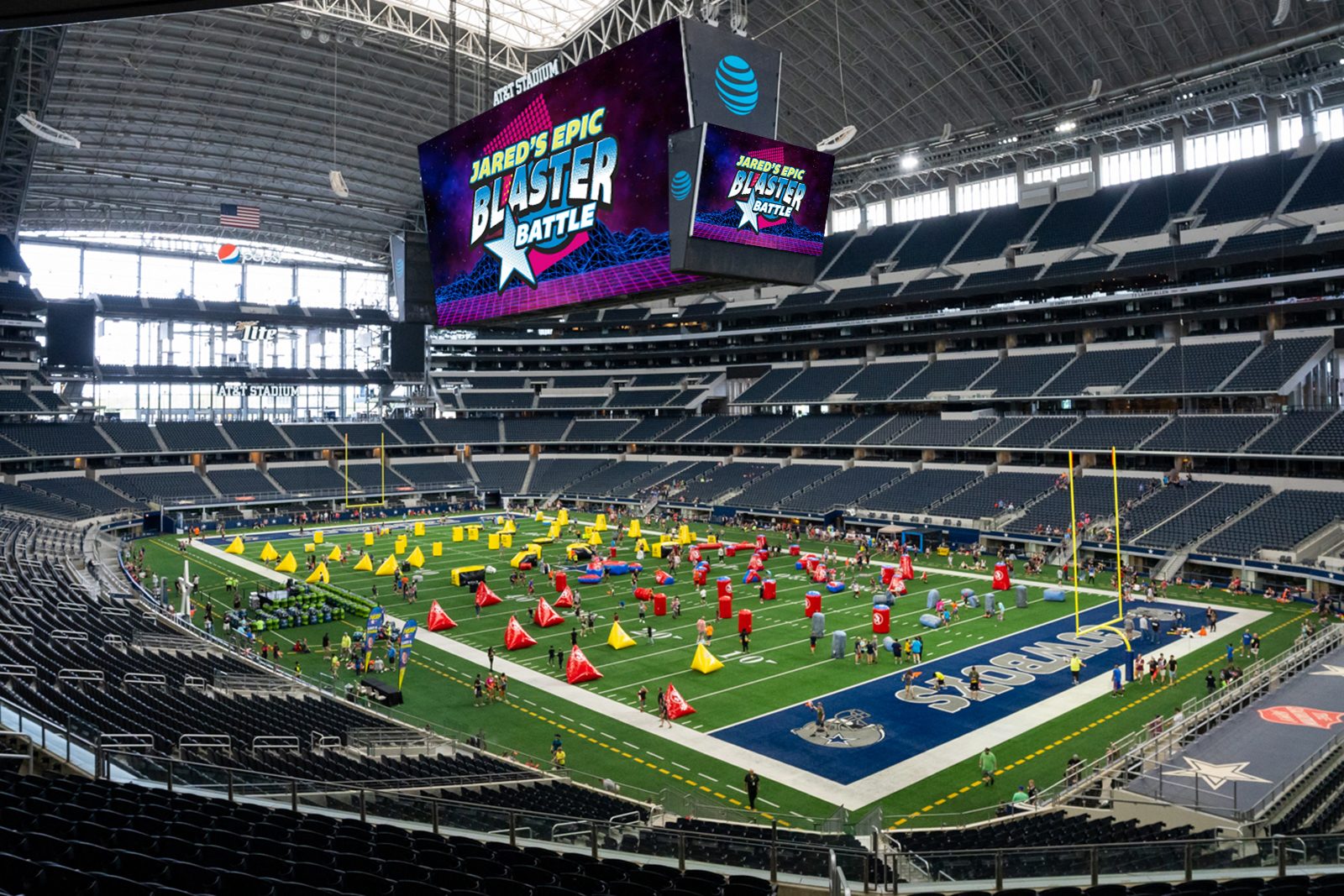 Inflatable bunkers set out across the field at AT&T Stadium before a Blaster Battle, with the event logo on the video boards