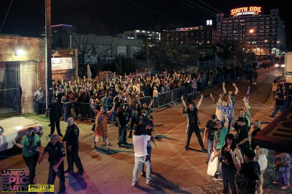A crowd filling the street at night during Jared's Epic Party