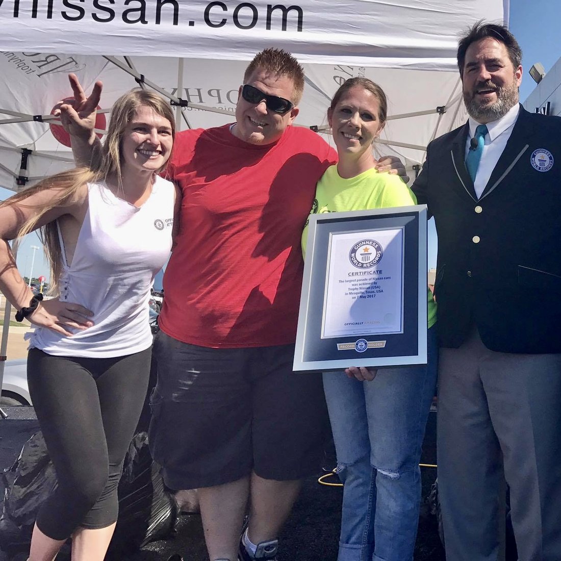 Jared Guynes with the Trophy Nissan team and a Guinness World Records adjudicator holding the certificate