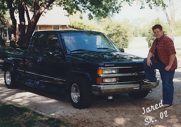 Jared Guynes in his 2002 senior photo, standing beside his blue Chevrolet pickup