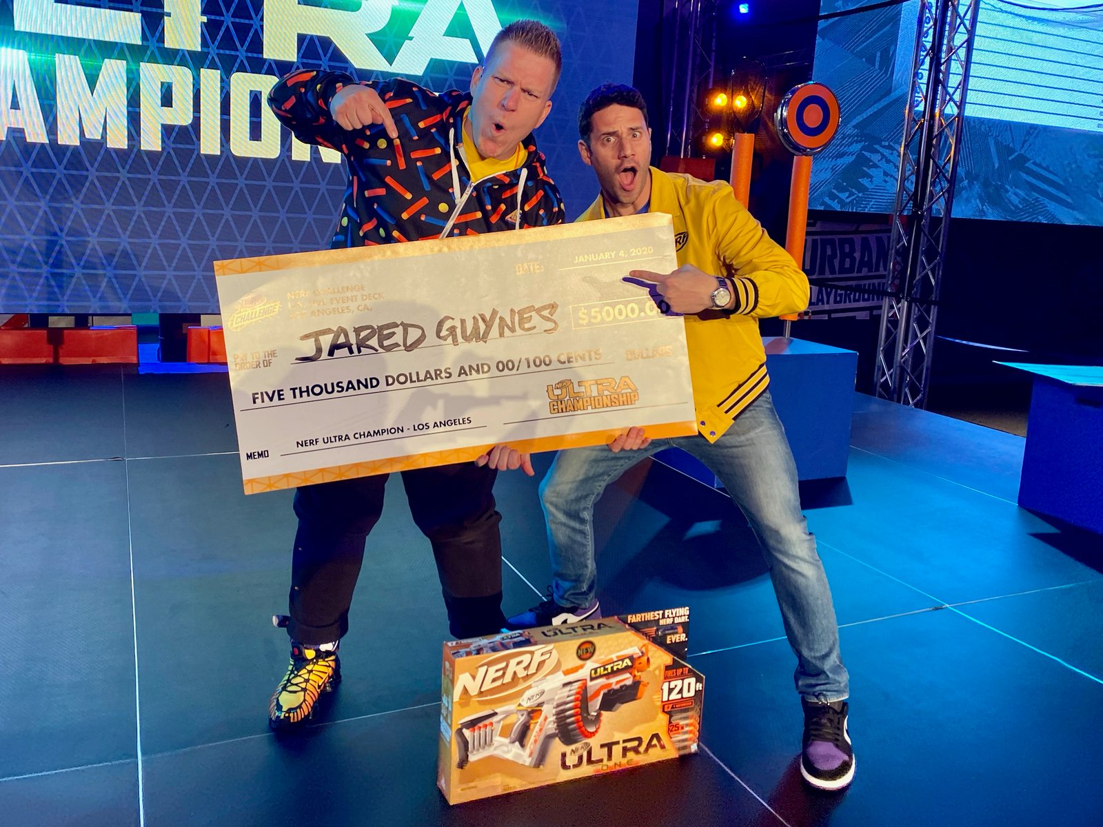 Jared Guynes holding the $5,000 Nerf Ultra Champion Los Angeles cheque on stage in January 2020