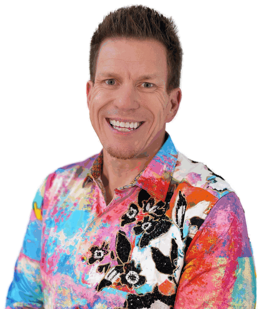 Jared Guynes grinning in a bright floral shirt, arms at his sides