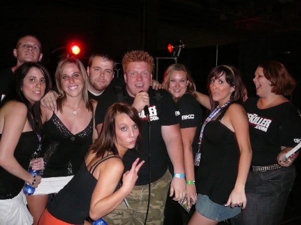 Jared Guynes with a crowd of friends in RiceKiller.com shirts at a nighttime party
